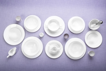 Obraz na płótnie Canvas Empty white dishes on grey background.