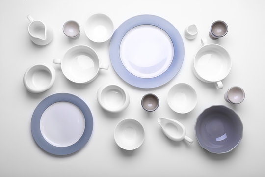 Empty white dishes on white background.