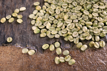 Green coffee beans on rustic wooden table