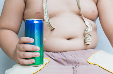 Diet. Obese fat boy holding soft drink can.