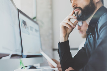 Closeup photo coworking process.Finance managers team work new idea.Young business crew working with startup modern office.Desktop computer on table,showing presentation.Blurred,film effect.Horizontal
