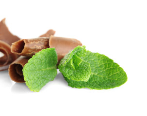 Milk chocolate chips with fresh mint, isolated on white