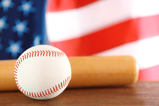 Baseball and bat on background of American flag. Popular sport concept