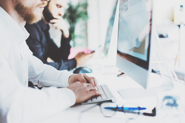 Coworking team.Startup manager new project work process.Photo young business crew working with document modern office.Desktop computer on table,reflection screen monitor.Blurred,film effect.Horizontal