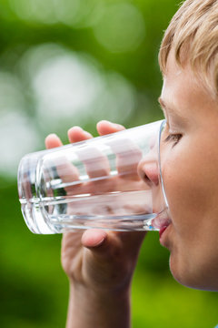 Boy drinking fresh water from glass