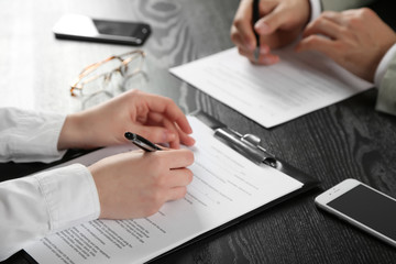 Human hands with pens working with documents at the desk closeup