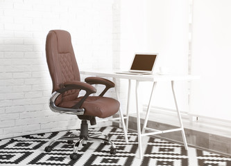 Modern workplace with office chair and laptop
