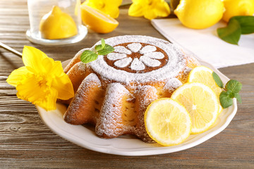 Delicious citrus cake on a white plate with lemons