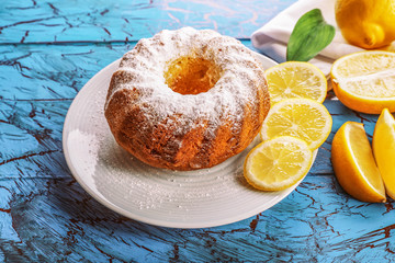 Obraz na płótnie Canvas Delicious citrus cake on a white plate with lemons.
