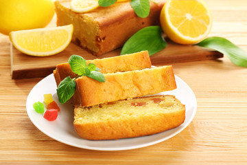 Pieces of delicious citrus cake on wooden table