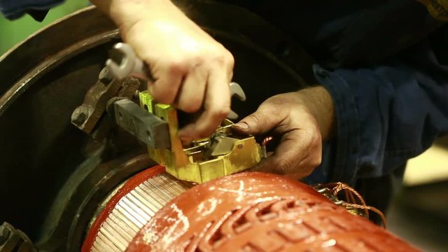 Mechanic repairing electric generator, repair of starter. motor mechanic repairs