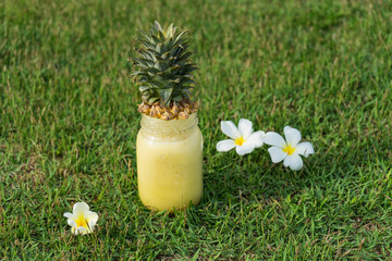 Pineapple smoothie, on a grass anasovy pineapple smoothie, tasty, sweet, healthy nutrition, detox, pineapple smoothie in the sea and on sand