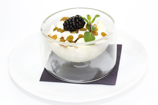 cottage cheese with sour cream and raisins on a white background