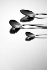 Different types of spoon on metallic background.