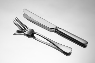 Knife and fork on metallic background.