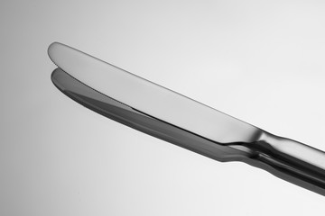 Silver knife on metallic background.