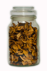 Some dried mushrooms in a glass jar.