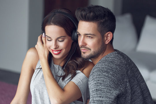 Young couple listening music at home