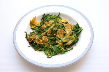 Cha-om Omelet in white plate(Acacia Pennata Omelet); Thai traditional food