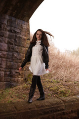 Fototapeta na wymiar Beautiful teenage girl walking on a wall