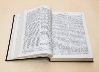 Obraz premium Bible is an open book with text on white paper background on the beige-pink color