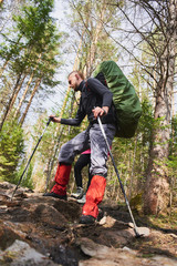 Tourist man walking on the mountainside
