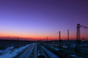 Fototapeta na wymiar Freight trains with carriages stand on railways at winter 