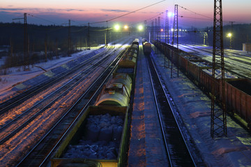 Fototapeta na wymiar Top view of freight train with carriages on railways at winter 