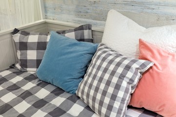 Fototapeta na wymiar Decorative Throw Pillows on A White Comfortable Sofa