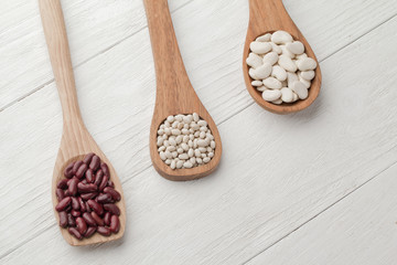 assorted beans in a wooden spatula