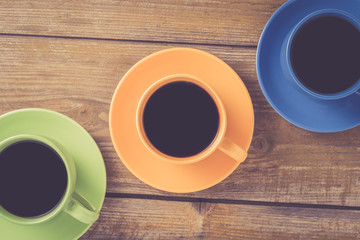 Coffee cups on yellow wooden table