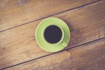 Coffee cup on yellow wooden table