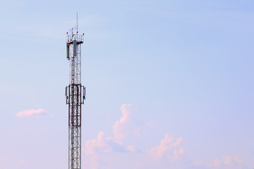 Tall modern cell tower, clouds and beautiful sky at summer 