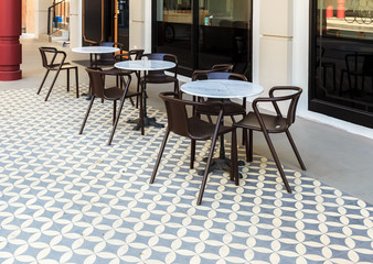 Cafe with tables and chairs on terrace