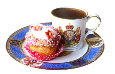 Vintage cup with tea and cupcake decorated with flower, isolated on white background