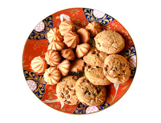 A stack of chocolate chip cookies in vintage red plate, isolated on a white background