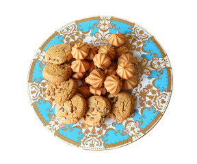 A stack of chocolate chip cookies in vintage blue plate, isolated on a white background