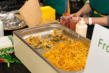Large pan of fried chicken and chips