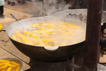 Large pot of cooking corn on the cob