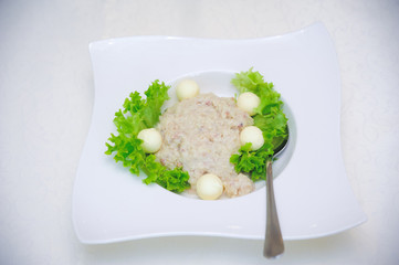 forshmak with a spoon on a white tablecloth