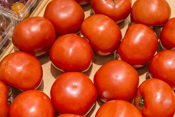 red tomato in market from market shelves real with flaws and bru
