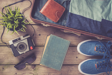 Men's casual clothing on wooden table. Travel concept