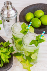 Two fresh mojitos cocktail. Mojitos with mint leaves, lime and ice
