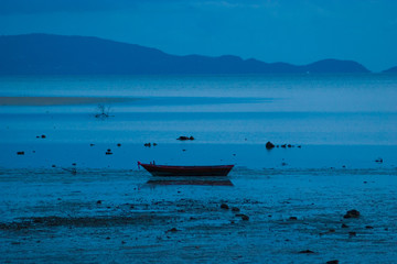 Obraz premium Picture of empty long tail boat on tropical beach at night. Ko li pe island. Horizontal