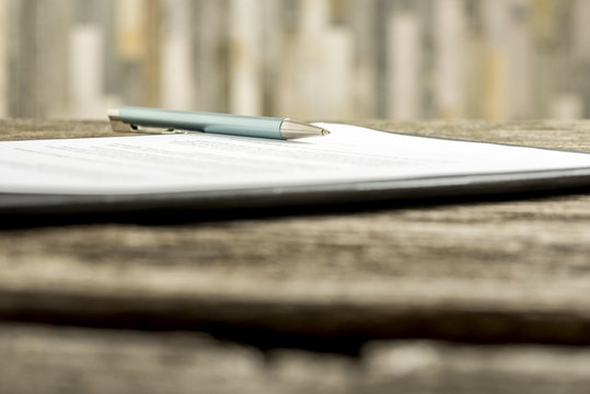 Low angle view of a pen lying on a contract