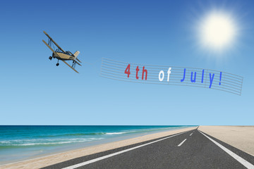 4th of july sign with flag colors at beach on plane banner on independence day