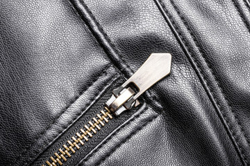 Black leather jacket metal zipper closeup.