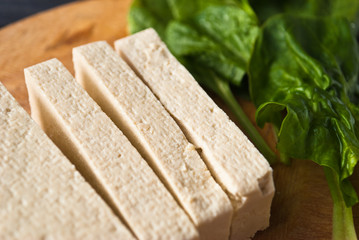 Slices of raw tofu and spinach