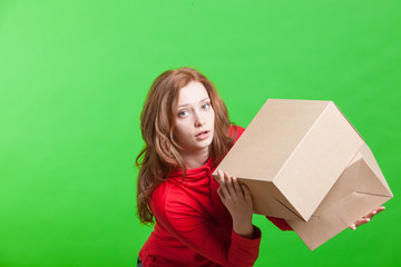 Woman holding cardboard boxes on green background