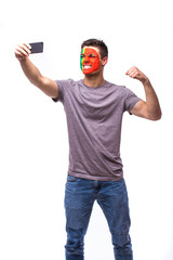Naklejka premium Selfie on phone of Portuguese football fan in game supporting of Portugal national teams on white background. European football fans concept.